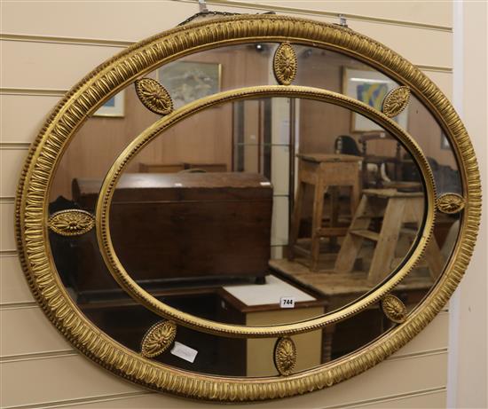 An Edwardian oval gilt gesso marginal framed wall mirror, W.110cm